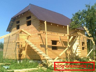 Amatorskie zdjęcie dwukondygnacyjnego drewnianego domu z prętami o wymiarach 9 na 9